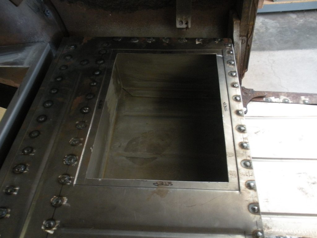 A metal door with rivets on it.