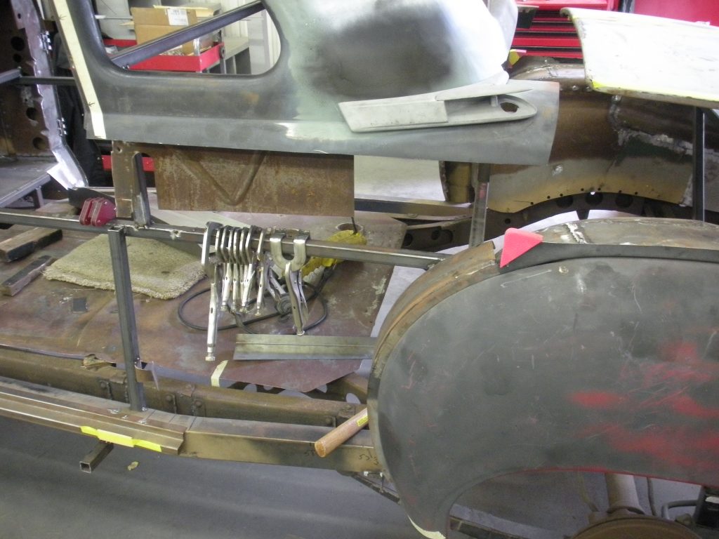 A metal piece of art is being worked on.
