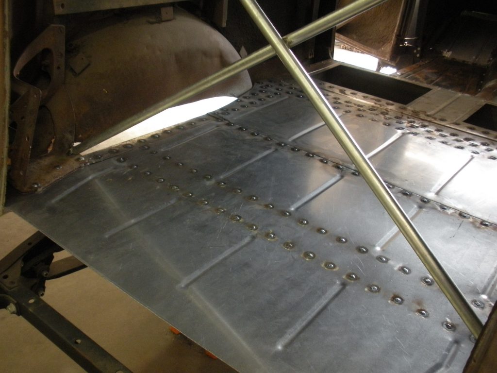 A metal sheet with rivets and a light