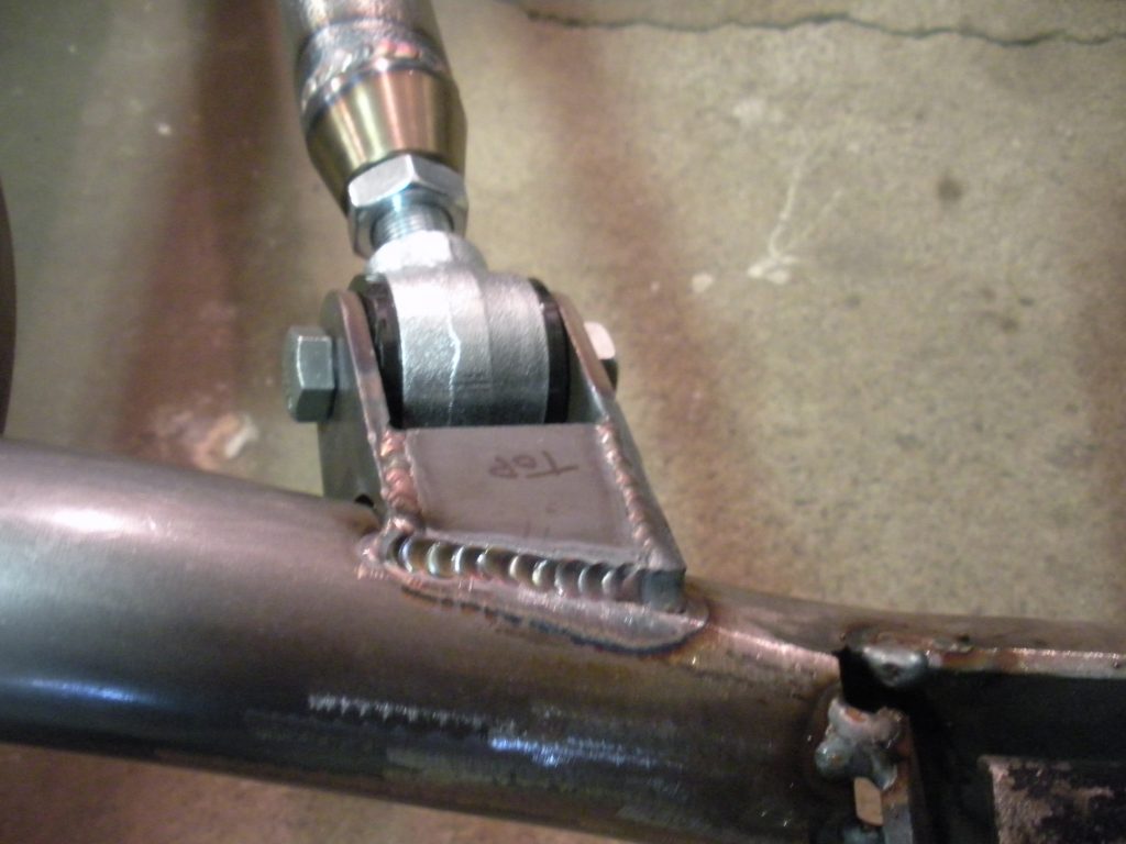 A pipe wrench is attached to the side of a pipe.
