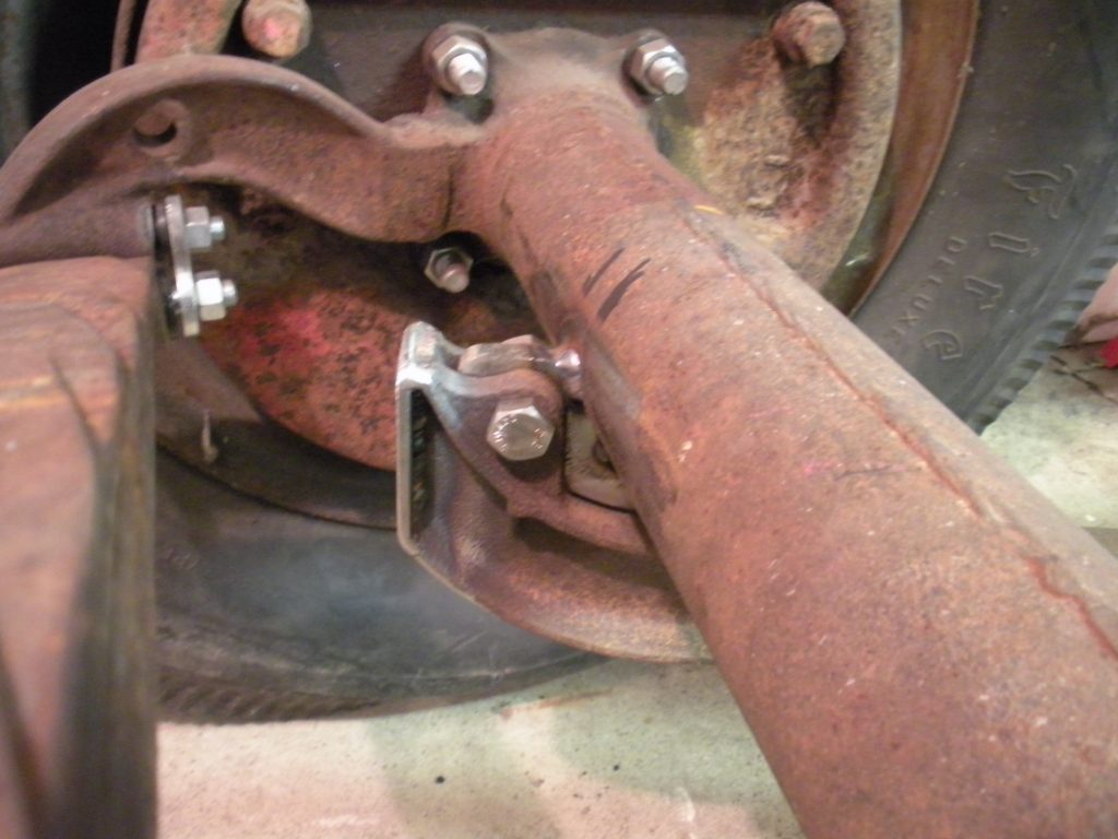 A person holding onto the wheel of an old car