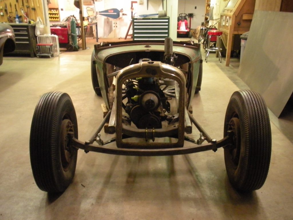 A car that is sitting in the middle of a garage.