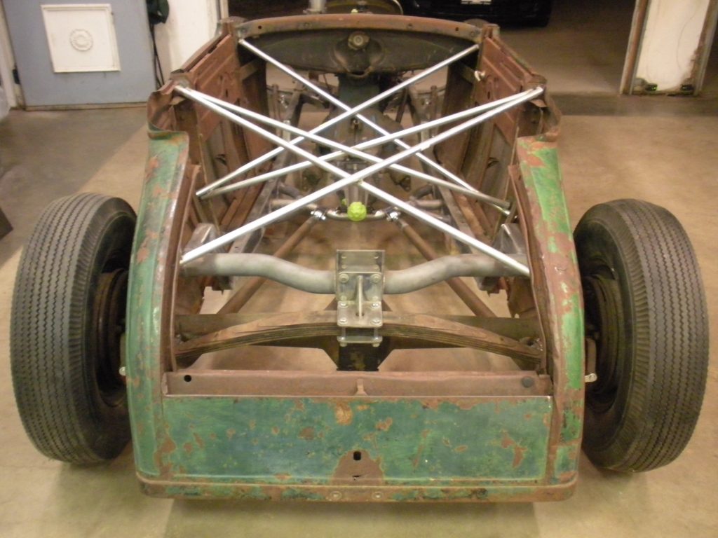 A car frame with the front end stripped off.