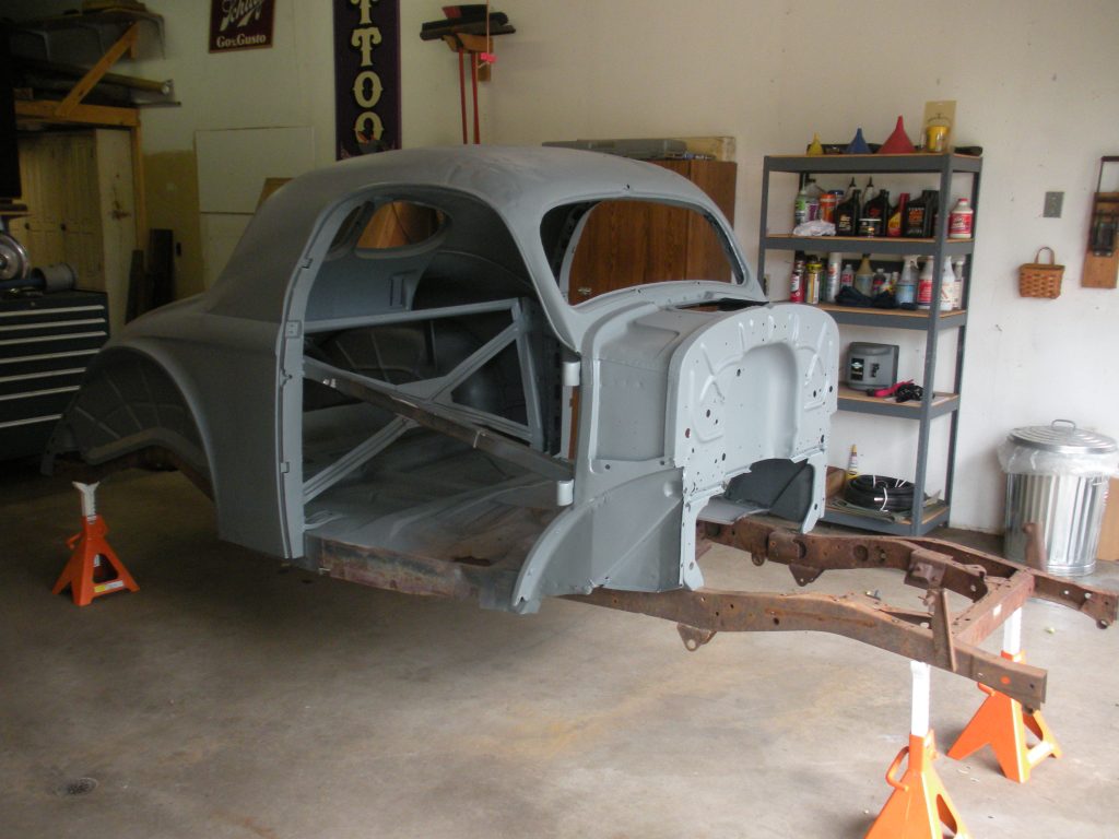 A car that is being built in the garage.