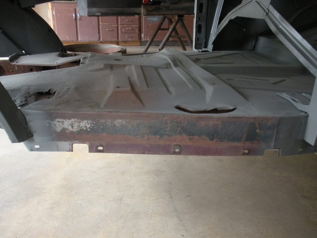 A metal piece of construction is sitting on the floor.