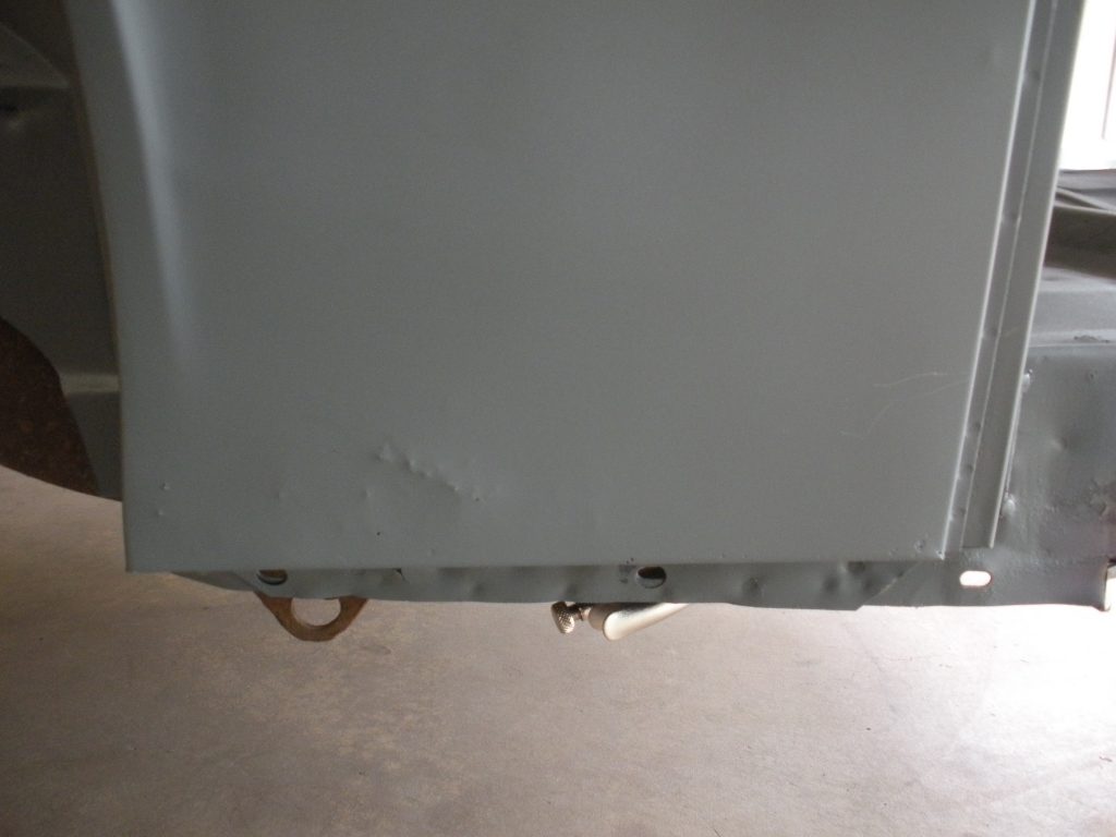 A close up of the door on an old metal cabinet.