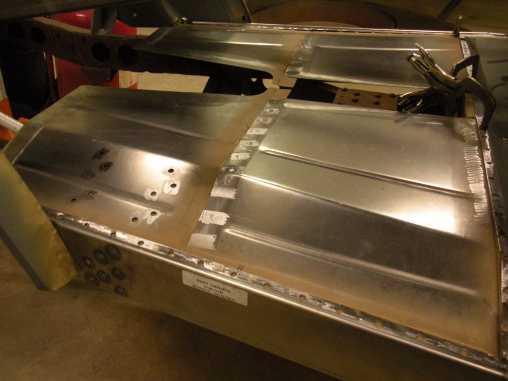 A metal piece of construction is being worked on.