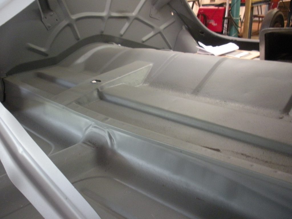 A car that is being worked on by someone.