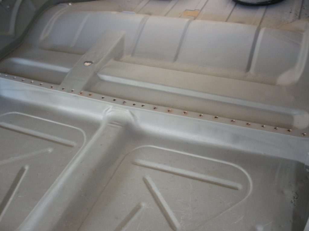 A white plastic tray with holes in it.