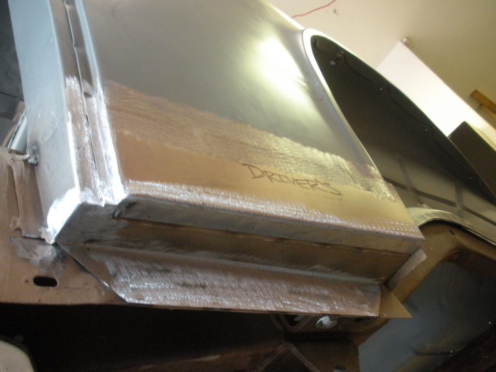 A metal box sitting on top of a wooden table.