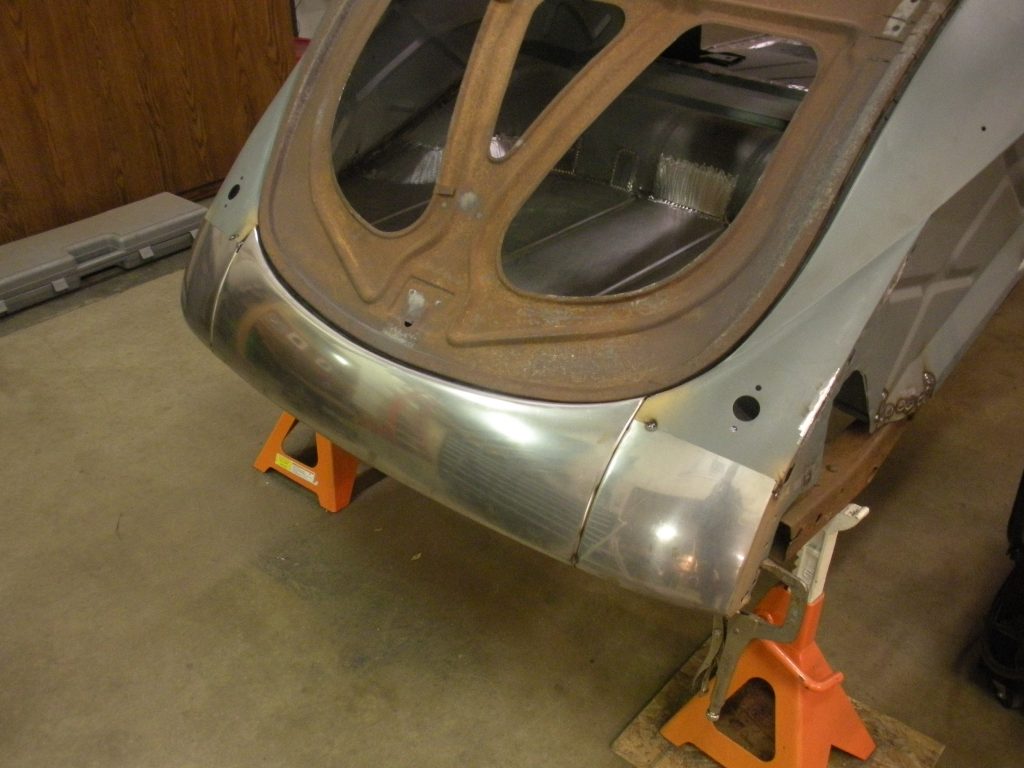 A car that is being worked on by some people.