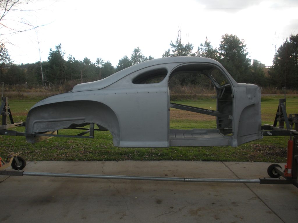 Gray car body shell on display.