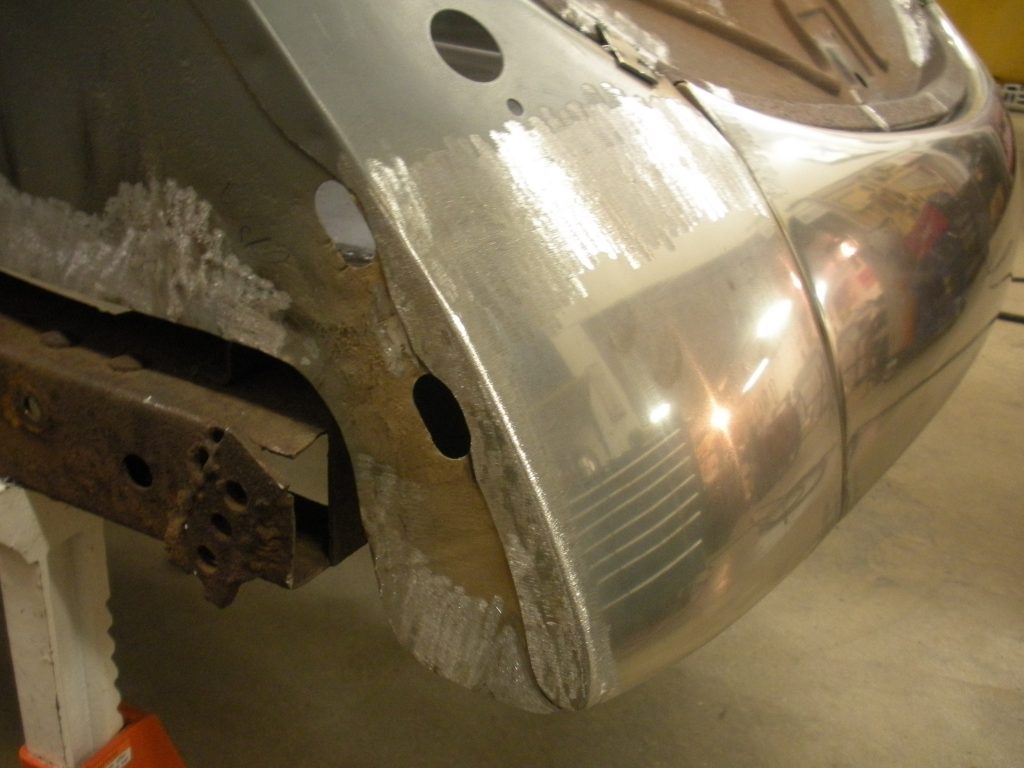 A close up of the side of an old car.