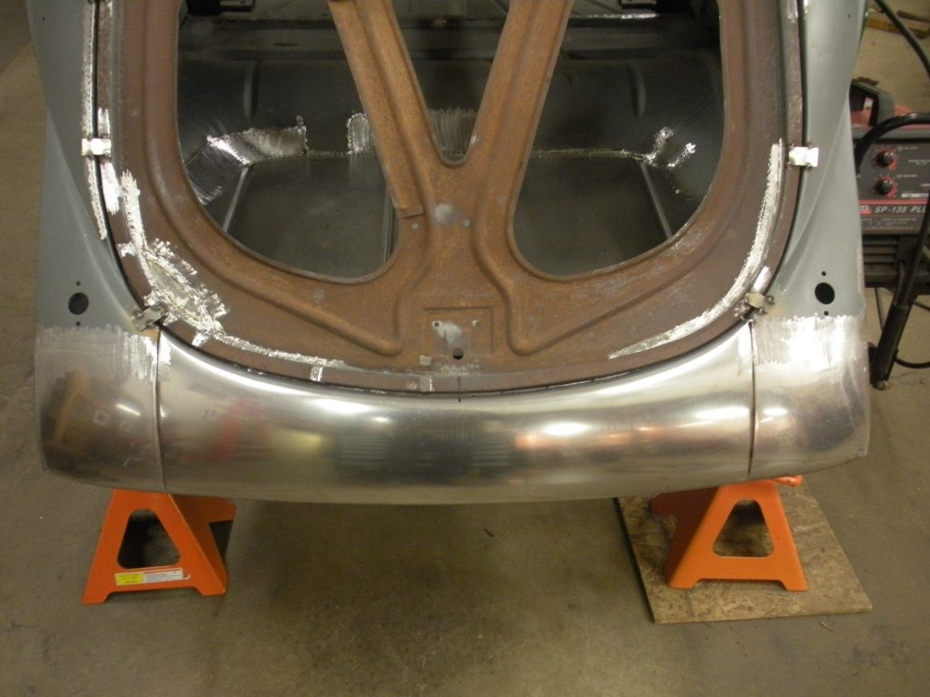 A car that is being worked on in the garage.