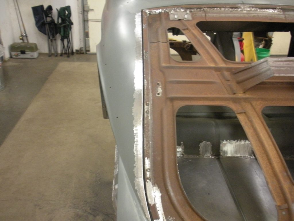 A car that is being worked on in the garage.