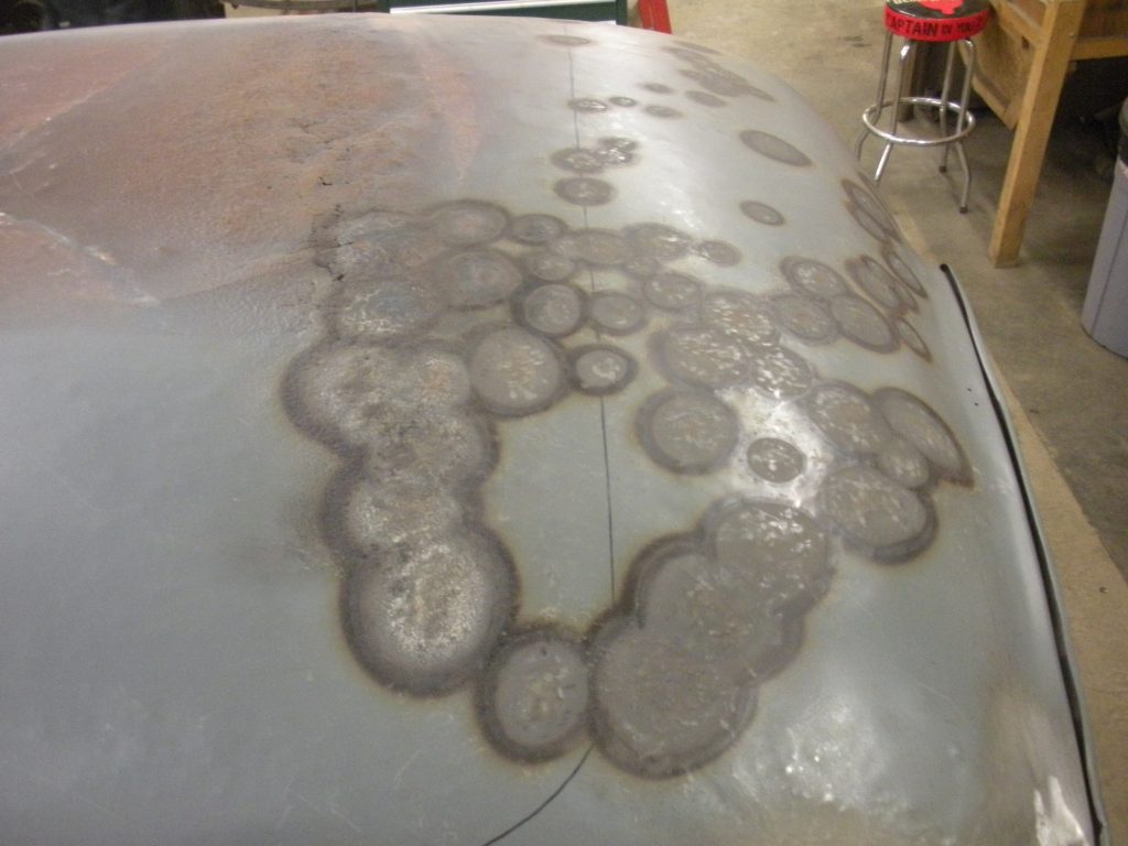 A close up of the top of a car with water on it