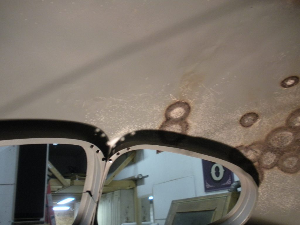 A mirror with some holes in it