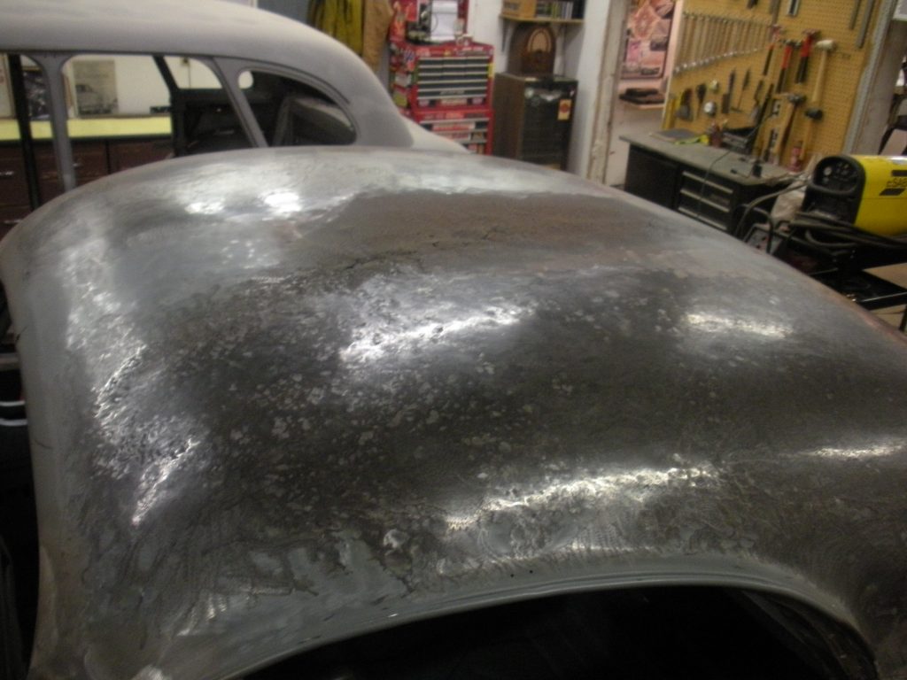 A car is being worked on in the shop.