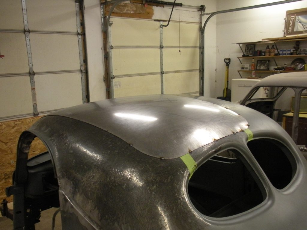 A car that is being worked on in the garage.