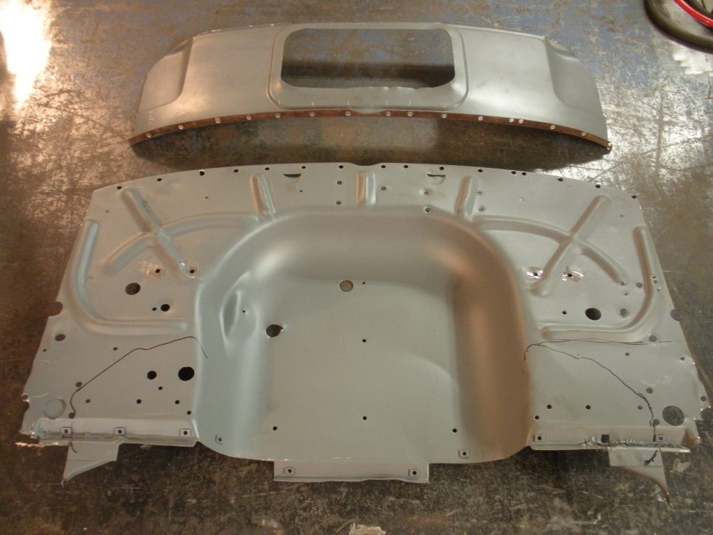 A car body shell with the bottom half of it being made.