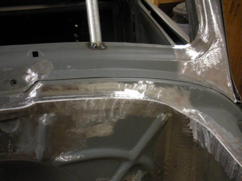 A car is being worked on in the shop.