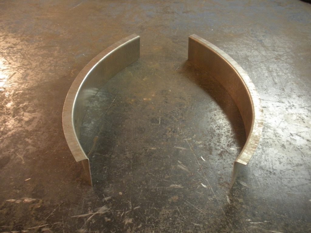 A pair of metal arches sitting on top of the floor.