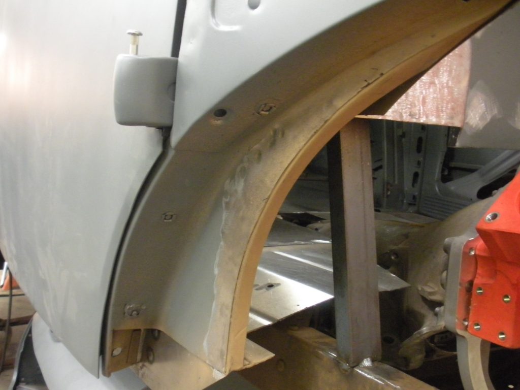 A close up of the side of an old car.