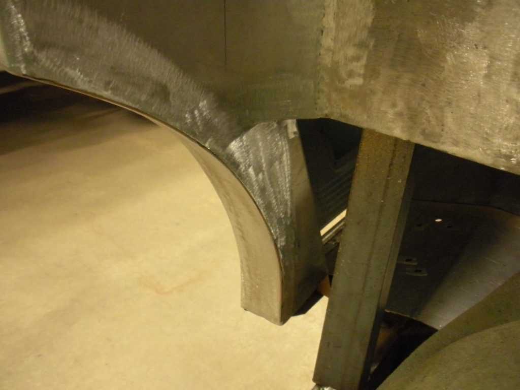 A metal structure with some concrete on the ground