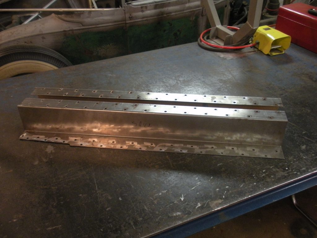 A metal table with two pieces of steel.
