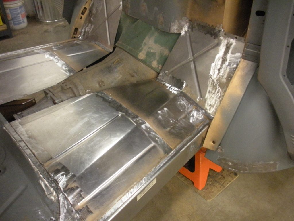A metal piece of construction is sitting on the floor.