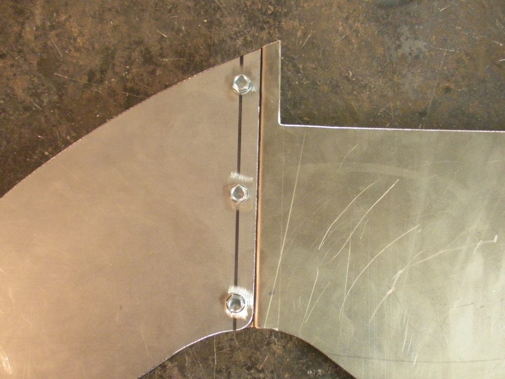 A metal piece of art with some holes in it
