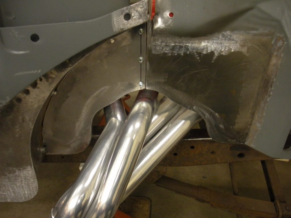 A pair of pipes are attached to the side of a car.