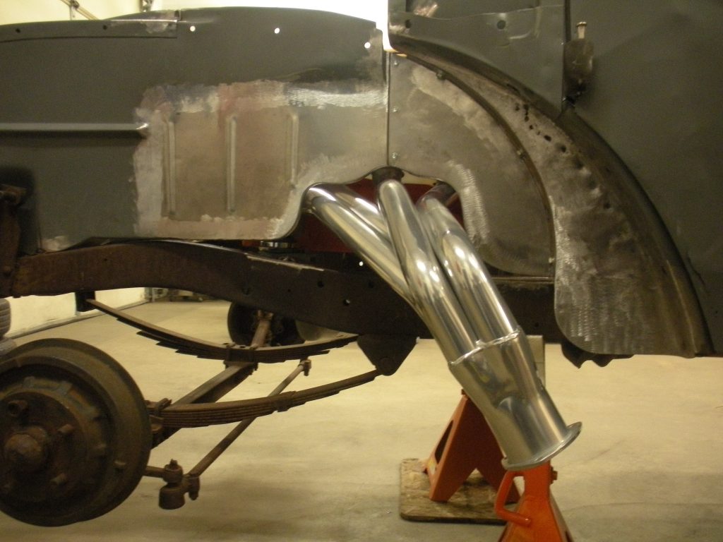 A car that is being worked on in the garage.