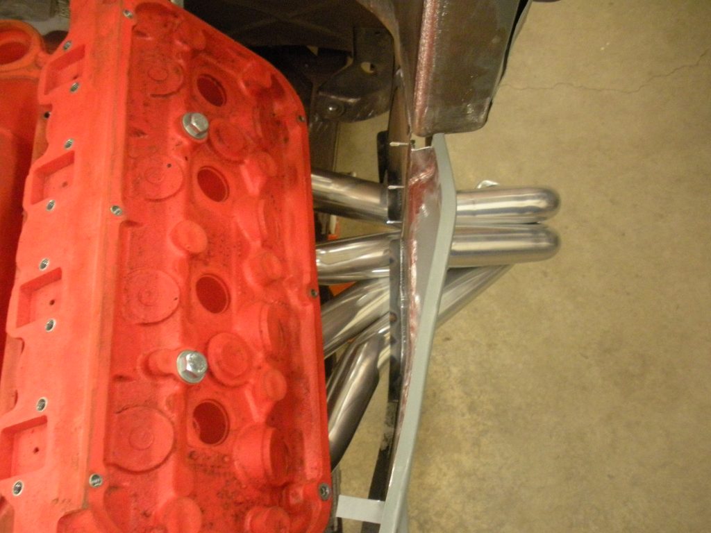 A red plastic piece of metal with a metal frame.
