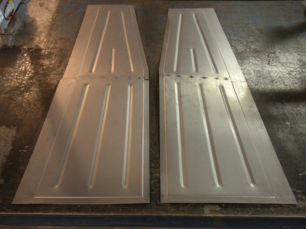Two white doors are sitting on the floor.