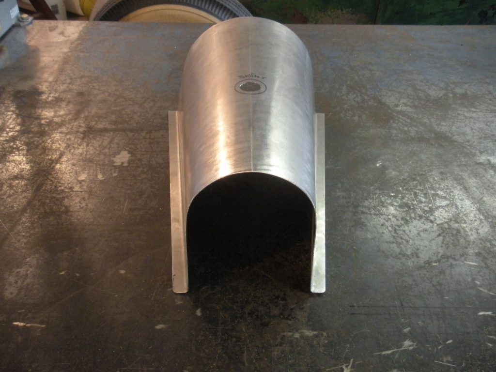 A metal pipe sitting on top of a table.