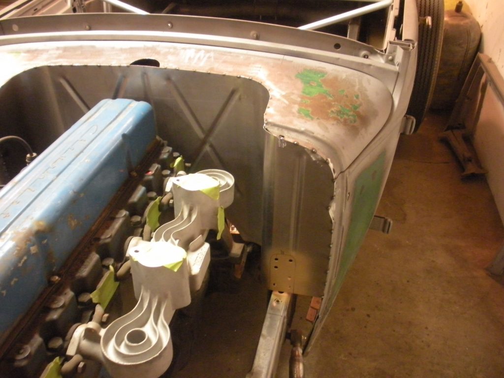 A close up of the back end of an old car.