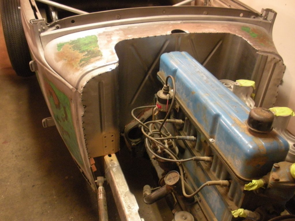 A car that is sitting in the dirt.