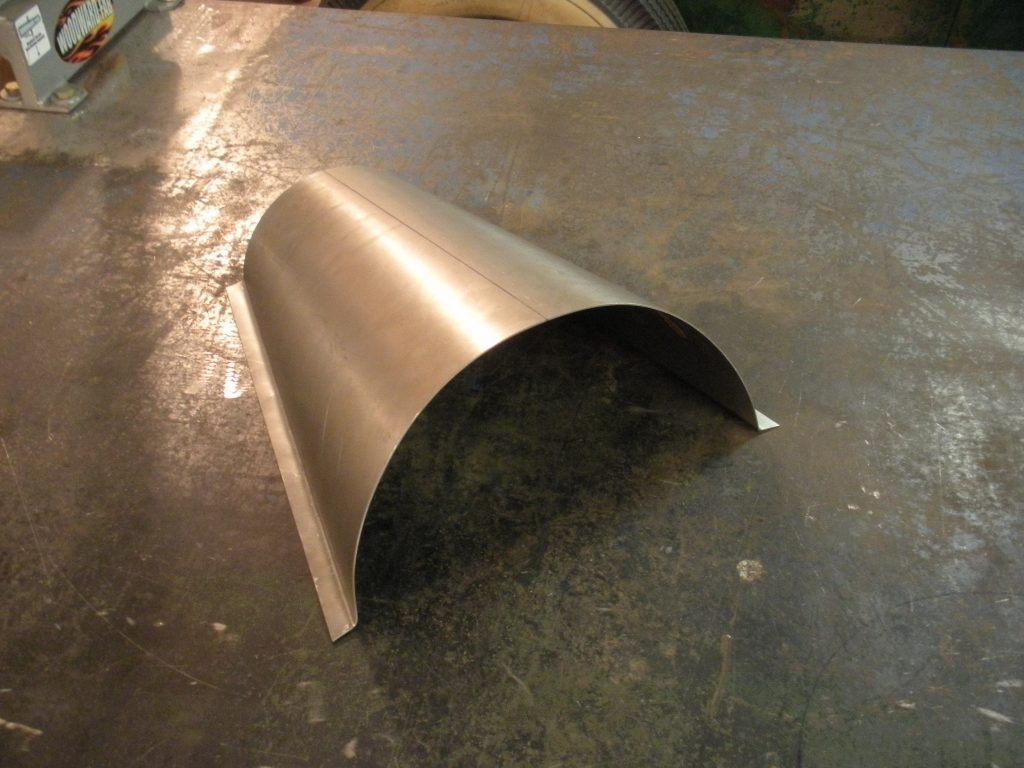 A metal piece of art that is on top of the floor.