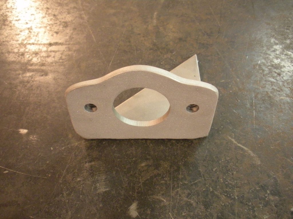 A white piece of metal sitting on top of a floor.