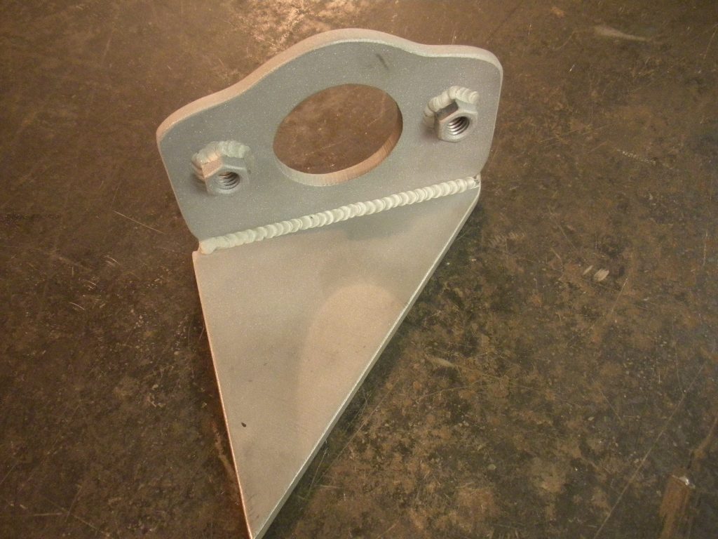 A metal piece of construction is sitting on the floor.
