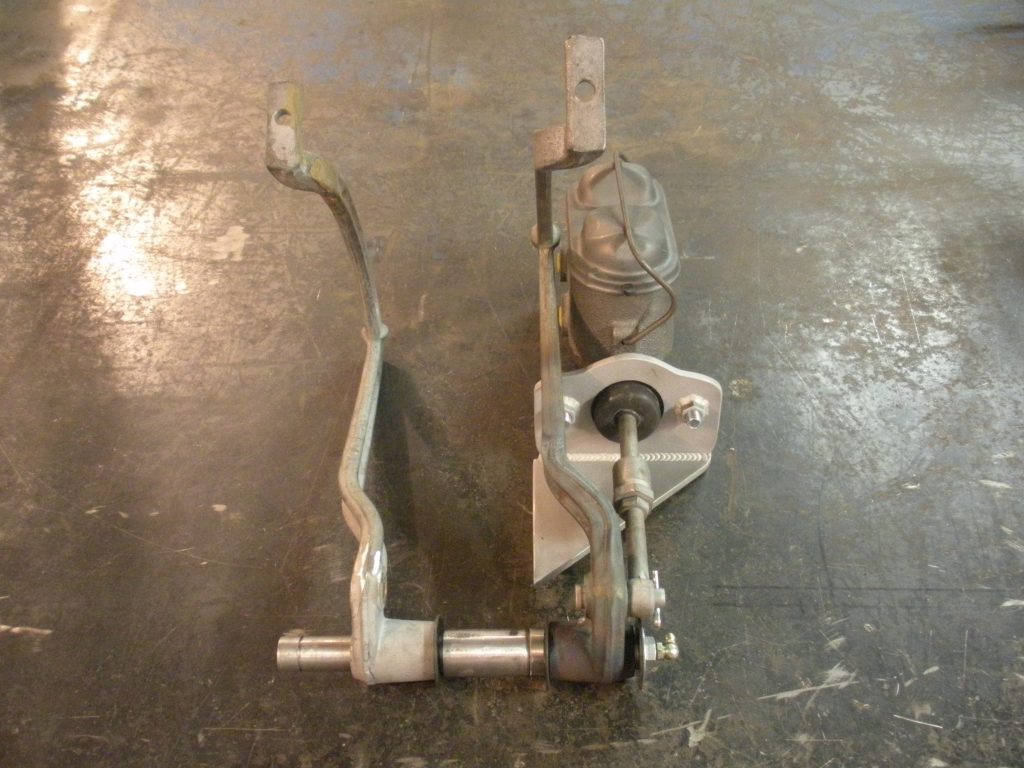 A pair of metal clamps sitting on top of the floor.