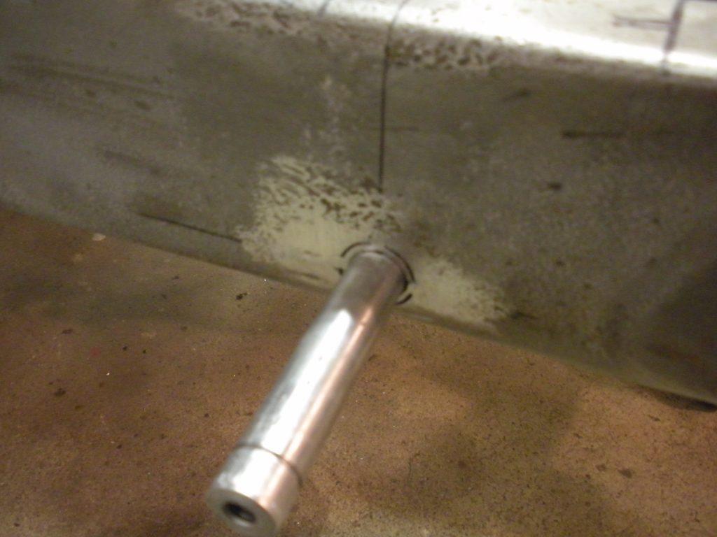 A metal pipe sitting on top of the floor.