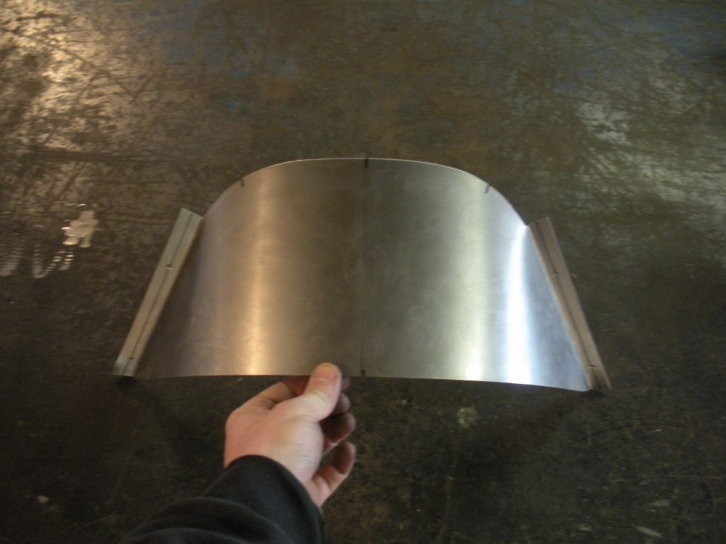 A person holding onto the metal plate