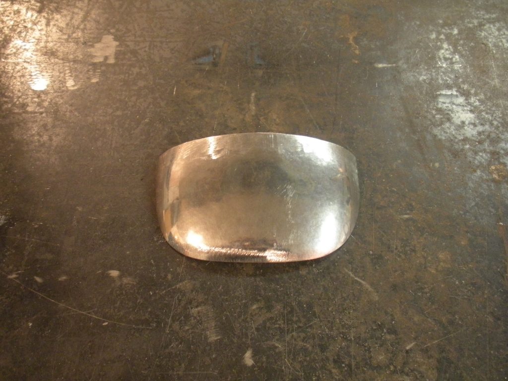 A silver object sitting on top of a table.