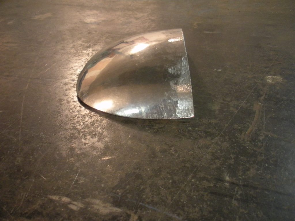 A metal object sitting on top of a concrete floor.