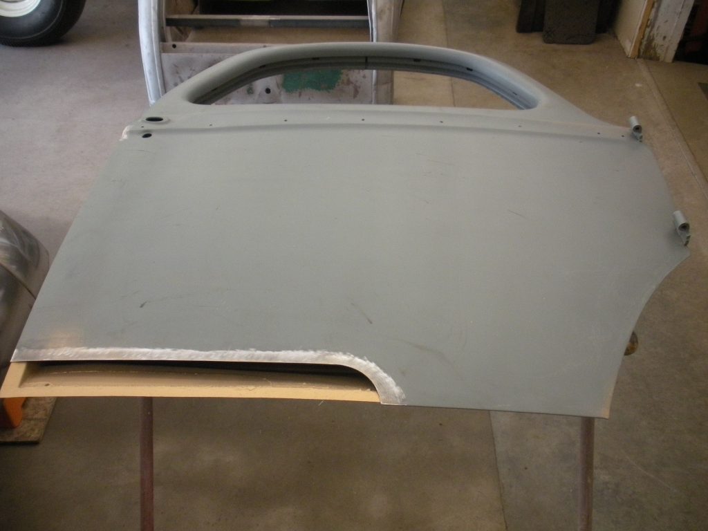 A table with two metal legs and one wooden handle.