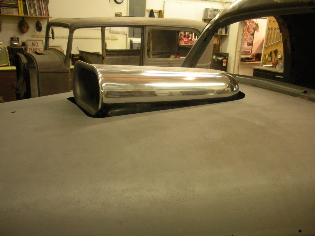 A car hood with the exhaust system on it.