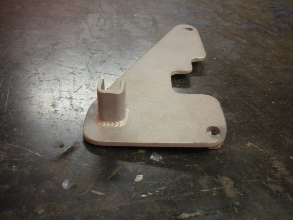 A white piece of metal sitting on top of a floor.
