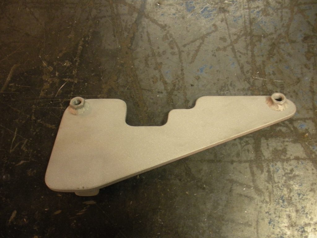 A white piece of metal sitting on top of a floor.